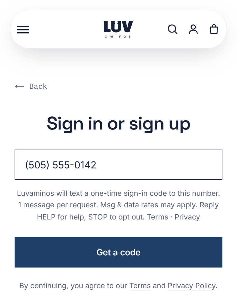 The Luvaminos sign-in screen on a phone, with a mobile number typed in the box and the text-message notice shown under it